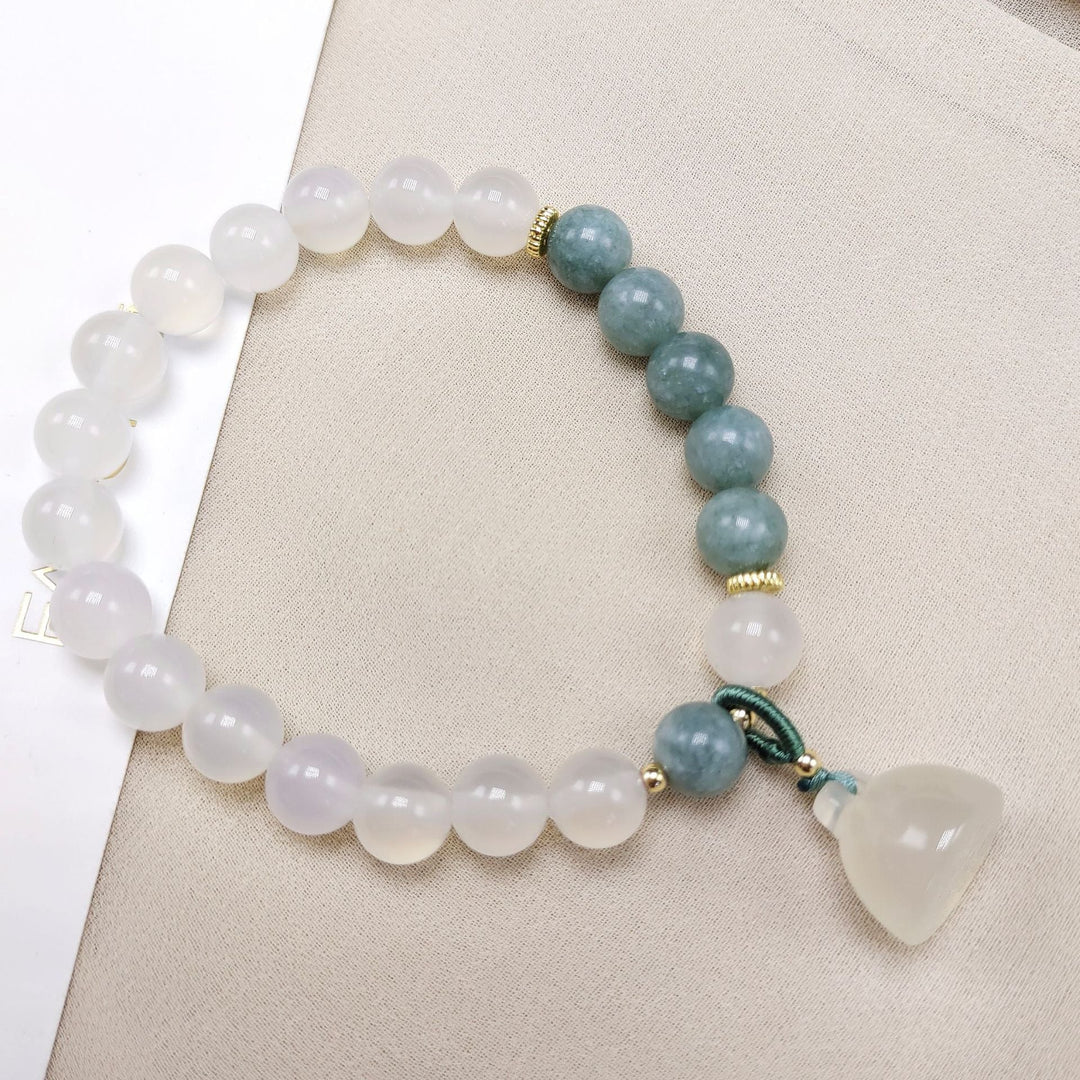 The lotus begets all creation �?White jade bracelet